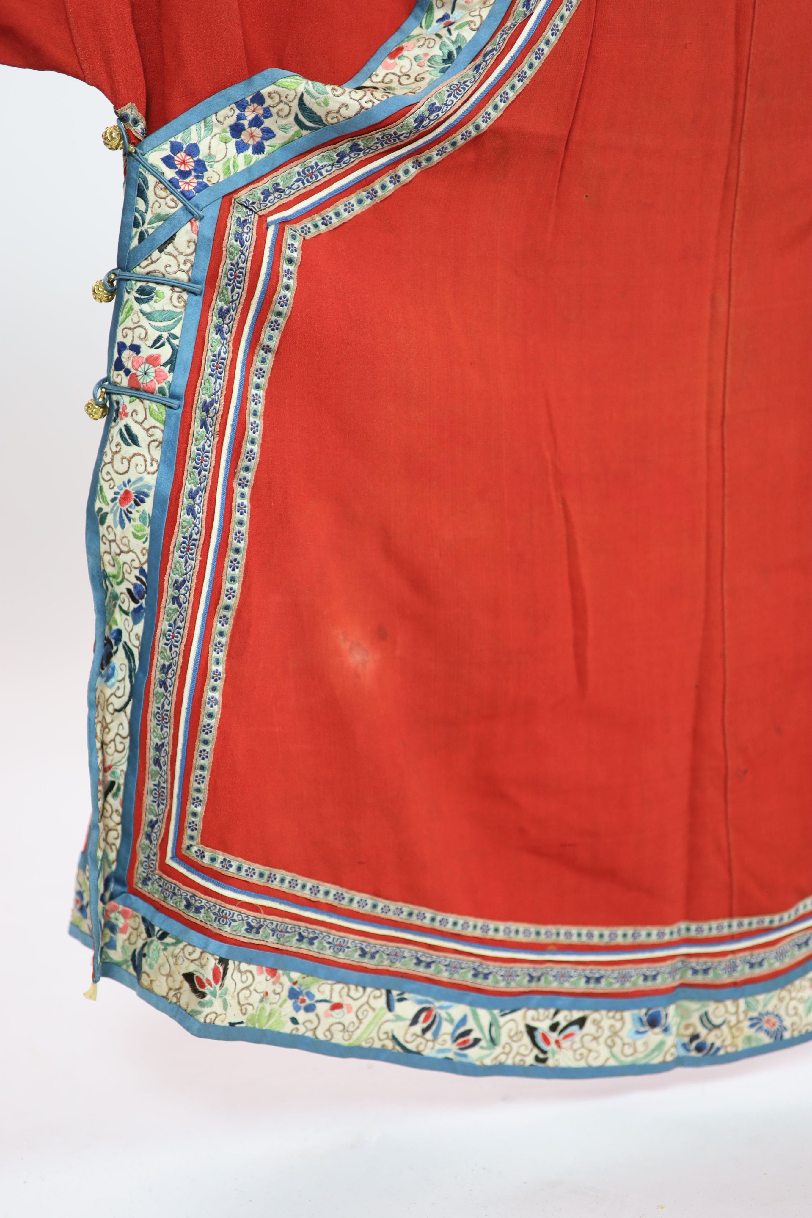 A Chinese red silk robe, late 19th century, 102cm drop